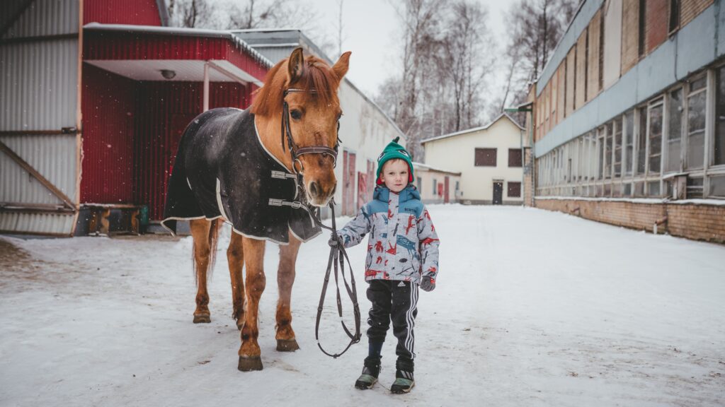 young boy with horse for hippotherapy