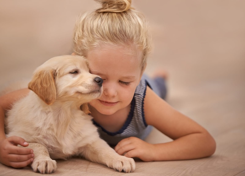 girl with lab puppy