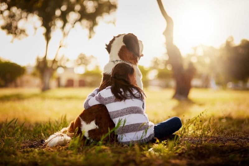 woman hugging dog