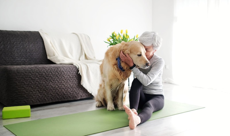senior woman hugging dog