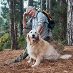 elderly man hiking with dog