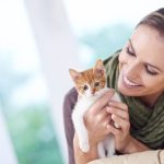 woman holding kitten
