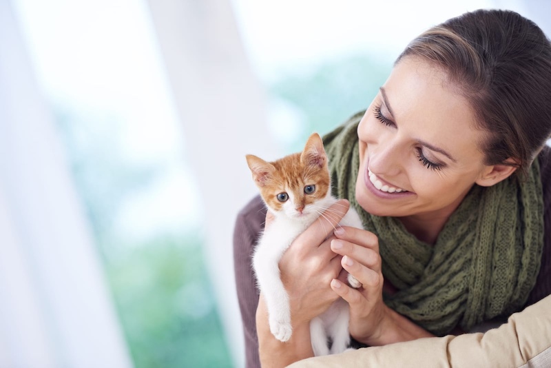 woman holding kitten