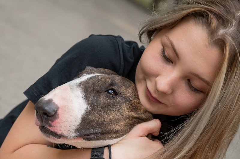 woman hugs dog