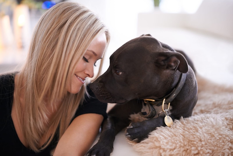woman smiling at dog